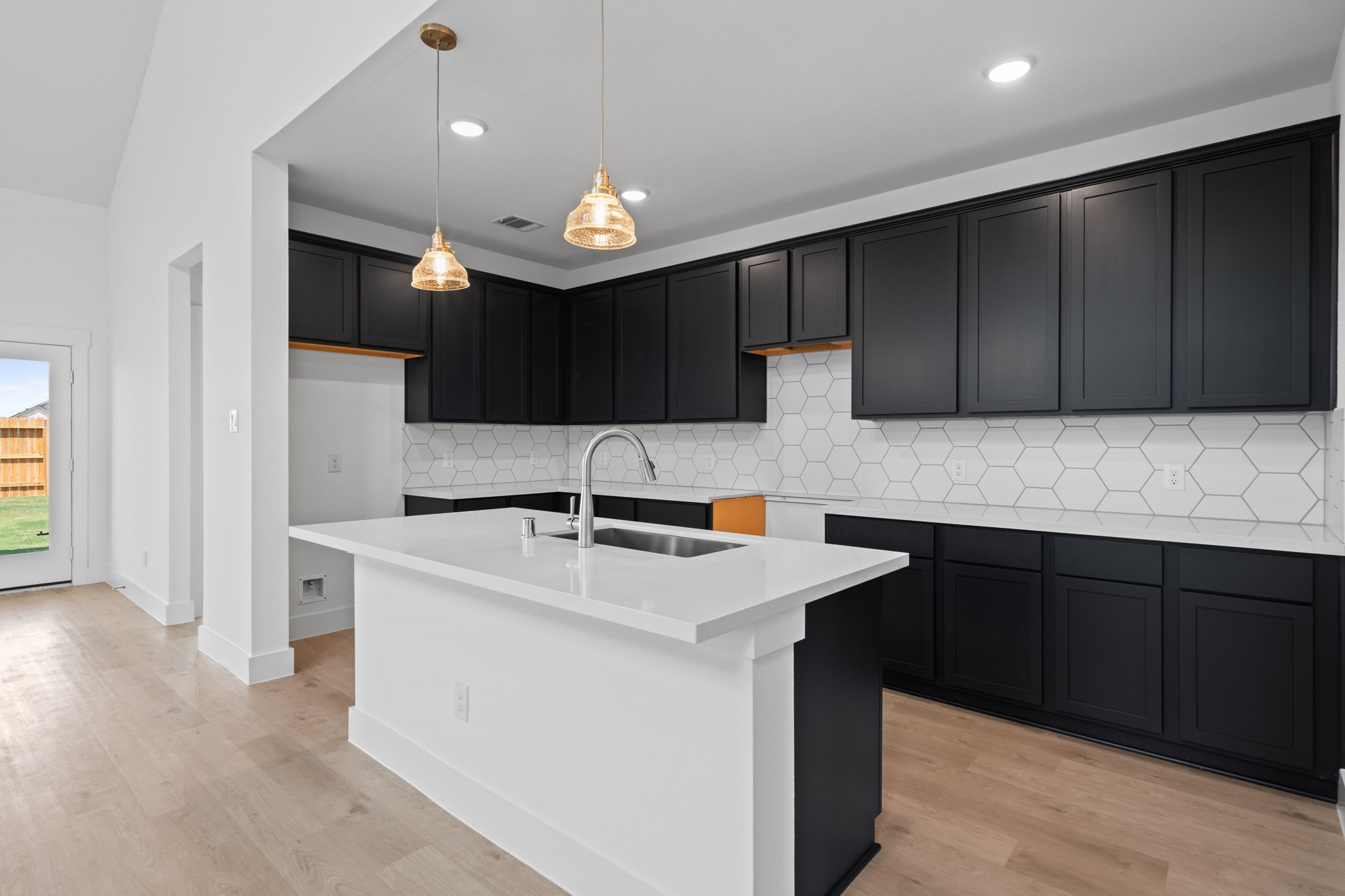 This beautiful brand new kitchen boasts stunning cabinetry that stretches to the ceiling, offering both style and ample storage for all your culinary treasures.
