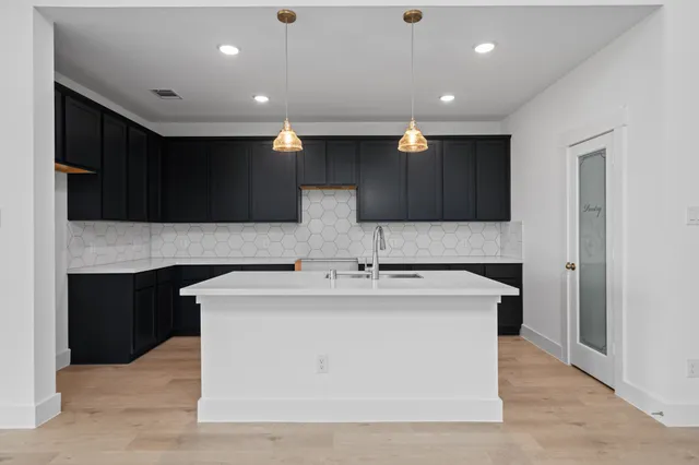 a kitchen with stainless steel appliances granite countertop a stove and a sink