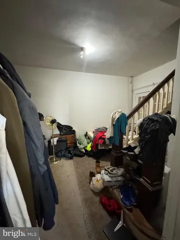 a living room with furniture kitchen and a wooden floor
