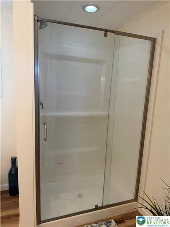 a bathroom with a glass shower door