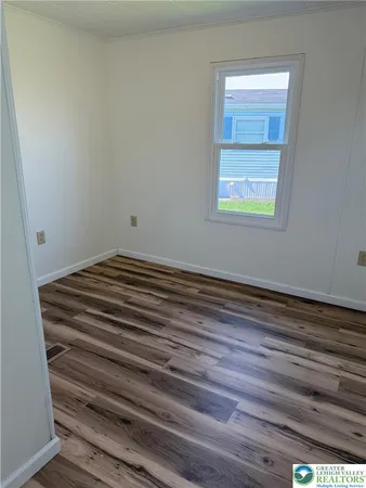 a view of a small space with closet and wooden floor