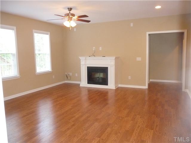 7557 Silver View Lane Raleigh, NC 27613 - Photo 18 of 25 an empty room with windows and a fireplace