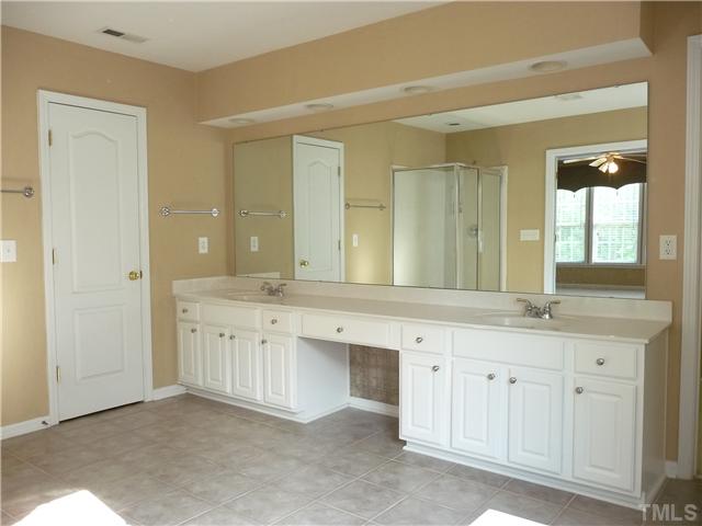 7557 Silver View Lane Raleigh, NC 27613 - Photo 20 of 25 a bathroom with a granite countertop double vanity sink a mirror and a