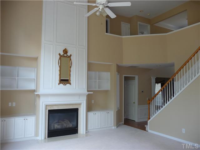 7557 Silver View Lane Raleigh, NC 27613 - Photo 5 of 25 a view of a livingroom with a fireplace and stairs