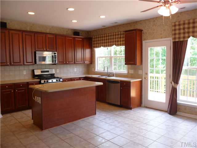 7557 Silver View Lane Raleigh, NC 27613 - Photo 7 of 25 a kitchen with stainless steel appliances granite countertop a stove a sink and a microwave