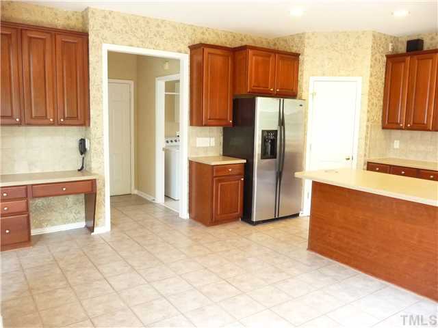 7557 Silver View Lane Raleigh, NC 27613 - Photo 8 of 25 a kitchen with stainless steel appliances a refrigerator and a stove top oven