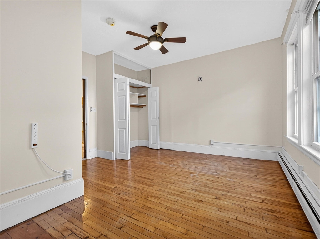 12 Braemore Road, Unit 2 Medford, MA 02155 - Photo 14 of 24 wooden floor in an empty room with a window