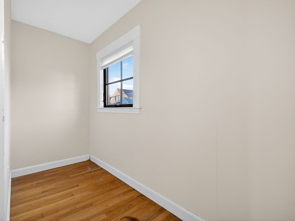 12 Braemore Road, Unit 2 Medford, MA 02155 - Photo 20 of 24 a view of empty room with wooden floor and fan