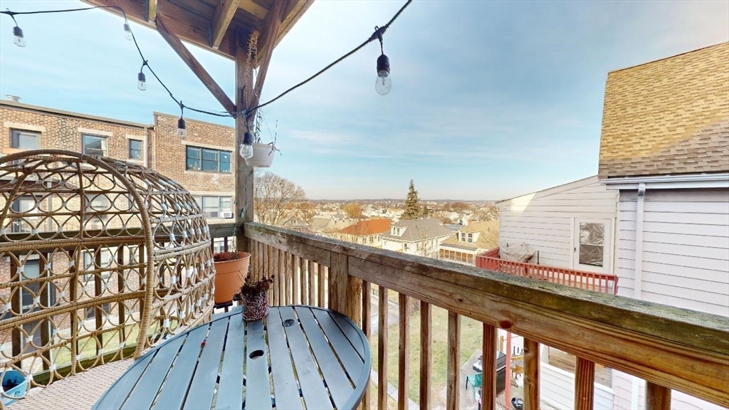 12 Braemore Road, Unit 2 Medford, MA 02155 - Photo 2 of 19 a view of a balcony with wooden floor