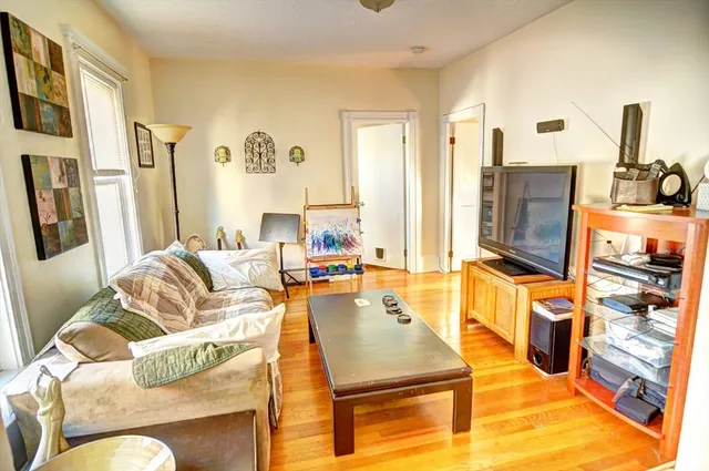 a living room with furniture stove and a flat screen tv
