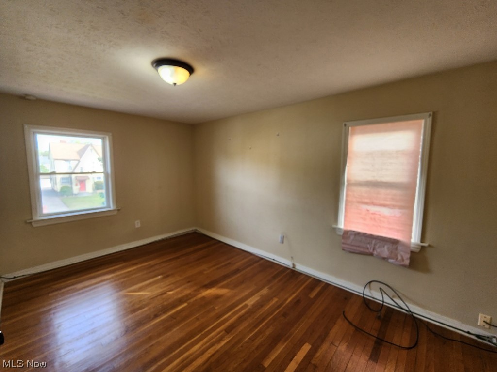 3602 Silsby Road University Heights, OH 44118 - Photo 12 of 19 Wood floored spare room featuring a textured ceiling