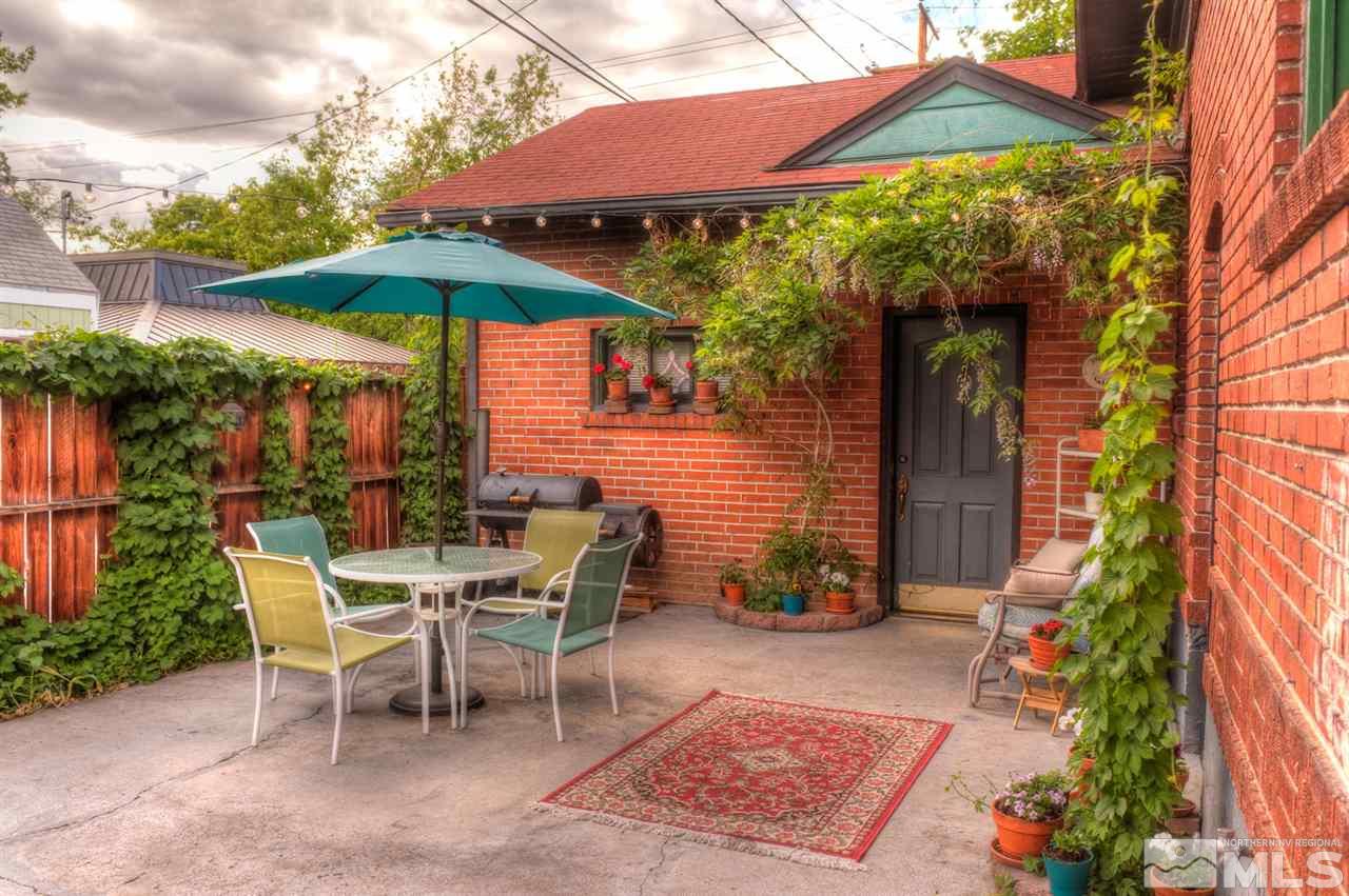 19 Winter Street Reno, NV 89503 - Photo 33 of 40 a patio with a table and chairs under an umbrella