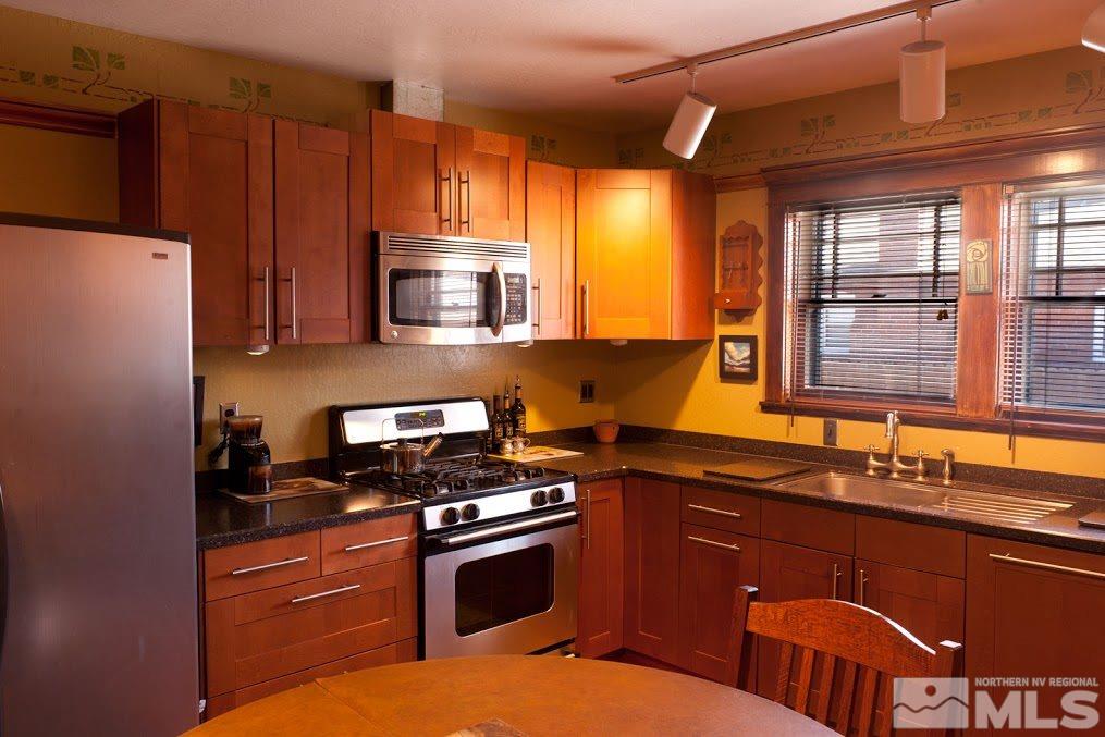 19 Winter Street Reno, NV 89503 - Photo 5 of 40 a kitchen with stainless steel appliances granite countertop a stove a sink and a microwave