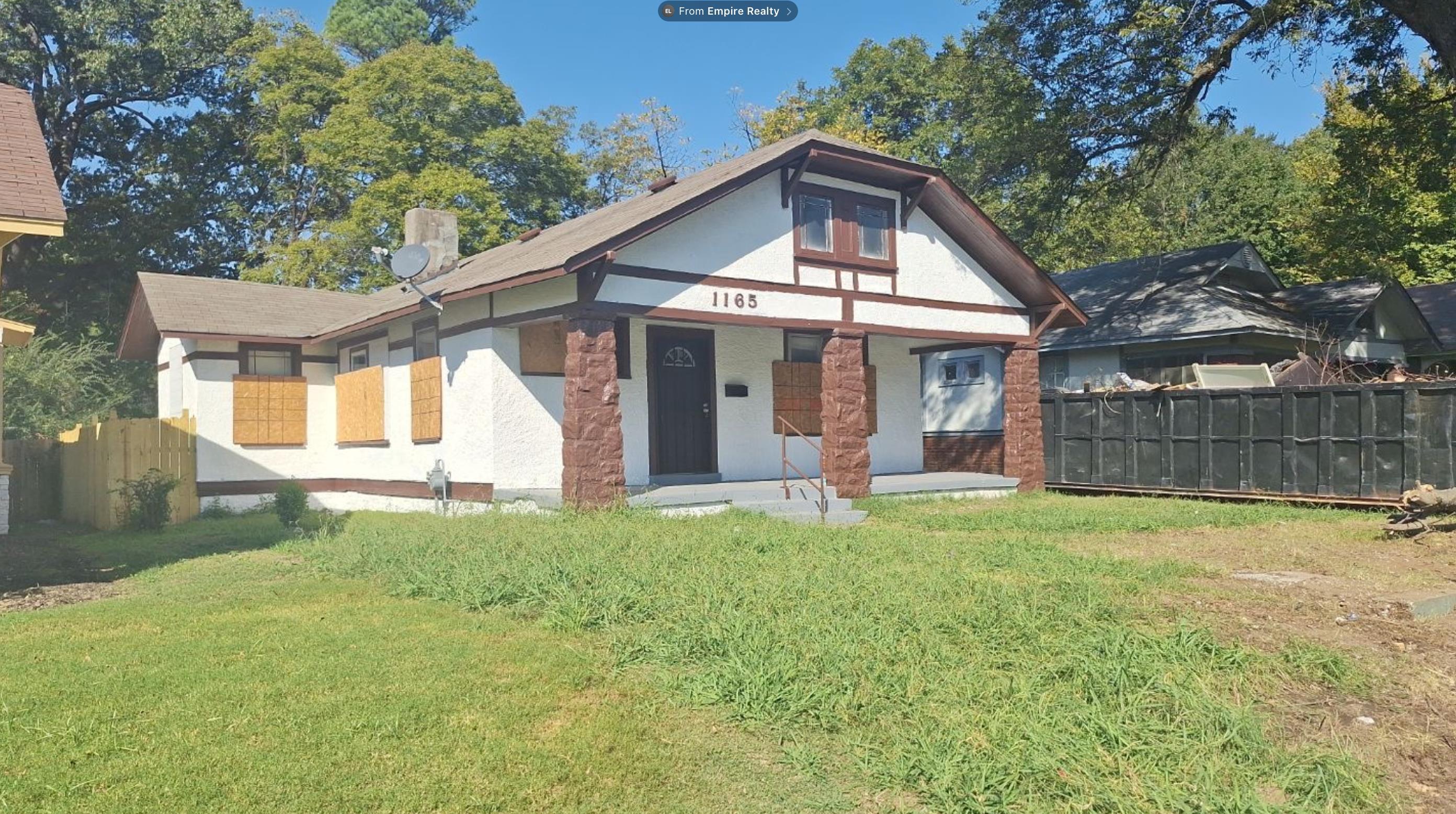 1165 Rayner Street Memphis, TN 38106 - Photo 4 of 16 Gabled roofline with exposed eaves, exterior stucco finish, stone-clad porch columns, and a front entry door