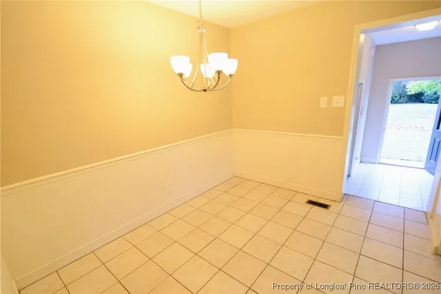 a kitchen with a refrigerator sink and cabinets