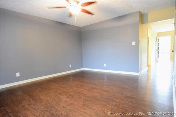 an empty room with a empty space and a ceiling fan