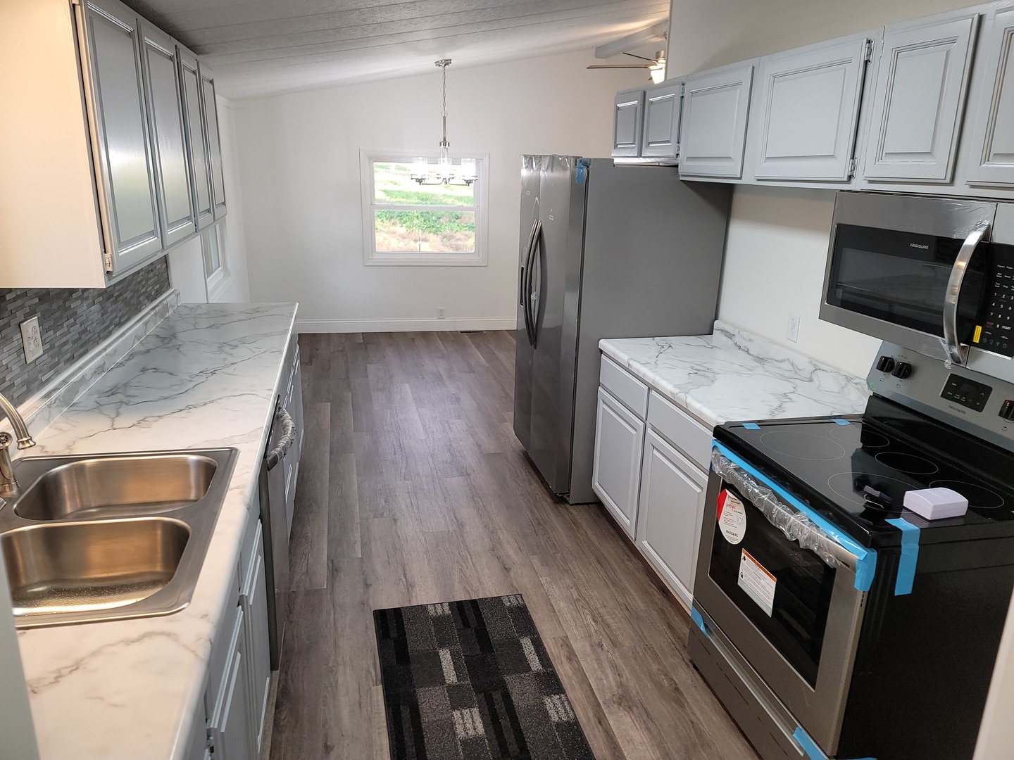 25544 Gaulrapp Road Rock Falls, IL 61071 - Photo 8 of 18 a kitchen that has a microwave a stove and a refrigerator