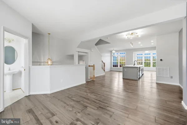 a view of a kitchen with wooden floor and a sink