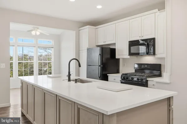 a kitchen with a sink a stove and a refrigerator