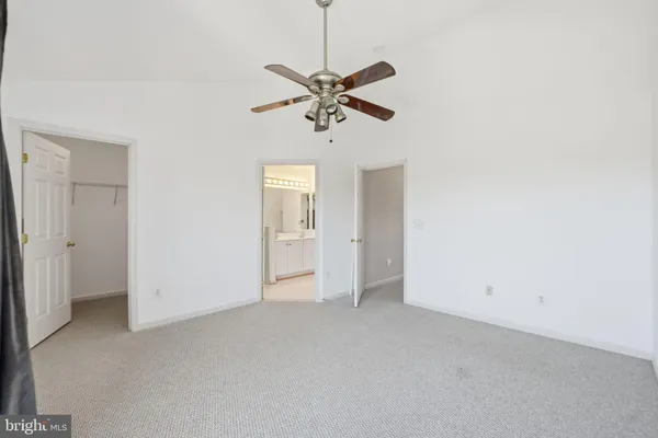 a view of a chandelier fan and entryway