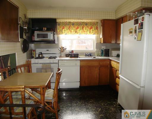 14 Barlow Road Edison, NJ 08817 - Photo 3 of 16 a kitchen with stainless steel appliances granite countertop a refrigerator a stove a sink a microwave and dining table
