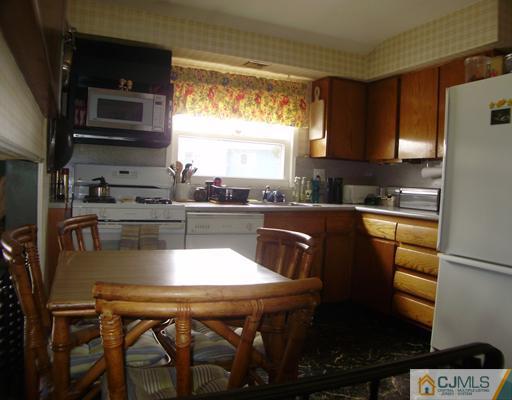 14 Barlow Road Edison, NJ 08817 - Photo 4 of 16 a kitchen with stainless steel appliances granite countertop a sink a stove a microwave a refrigerator and cabinets