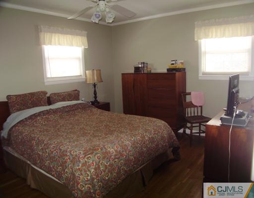 14 Barlow Road Edison, NJ 08817 - Photo 8 of 16 a bedroom with a bed and wooden floor