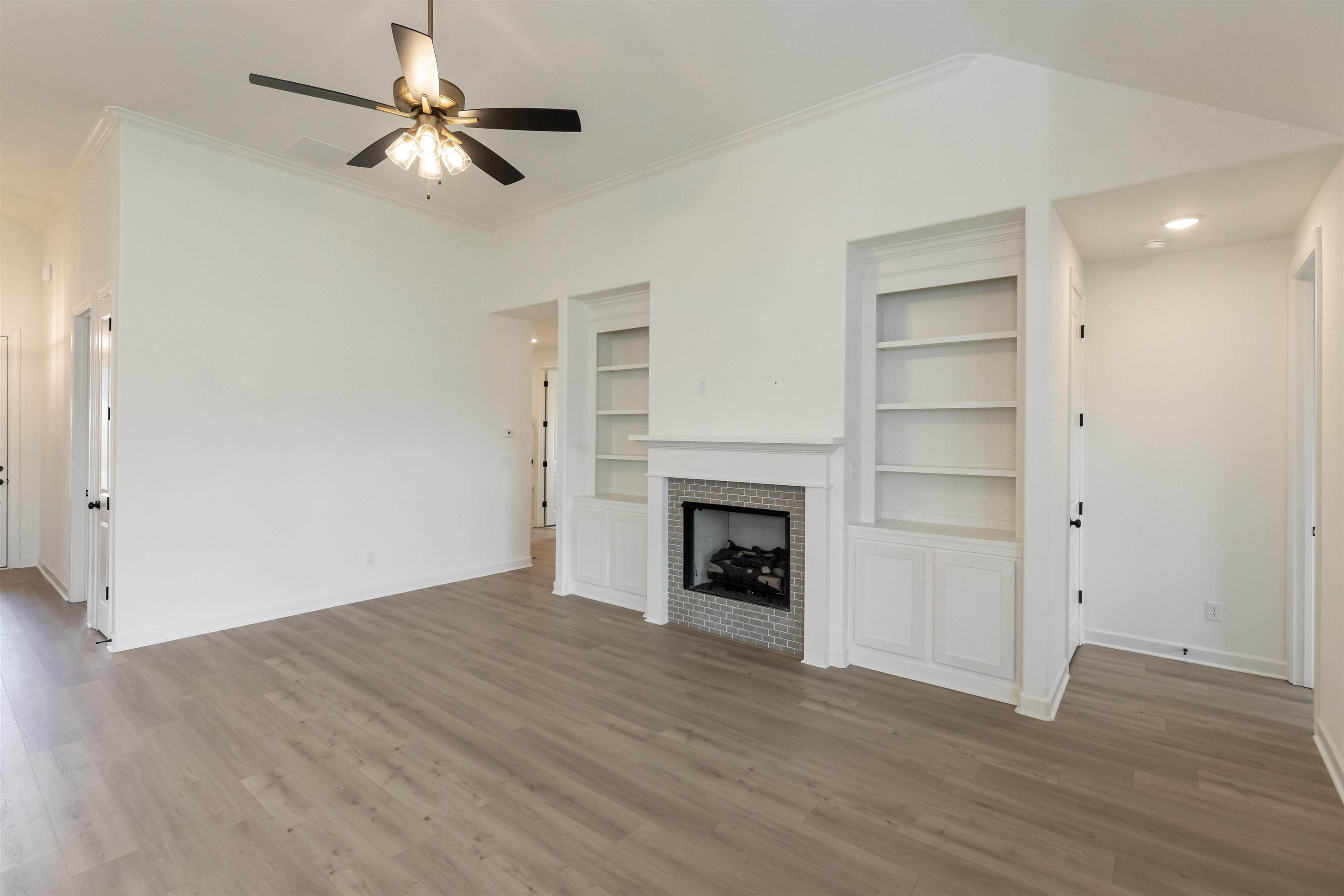 95 Misty Rdg Loop Oakland, TN 38060 - Photo 3 of 23 an empty room with wooden floor fan and windows