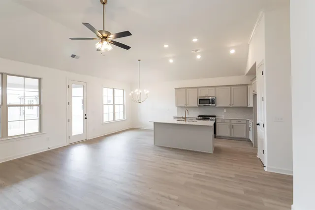 a view of kitchen with sink and wooden floor