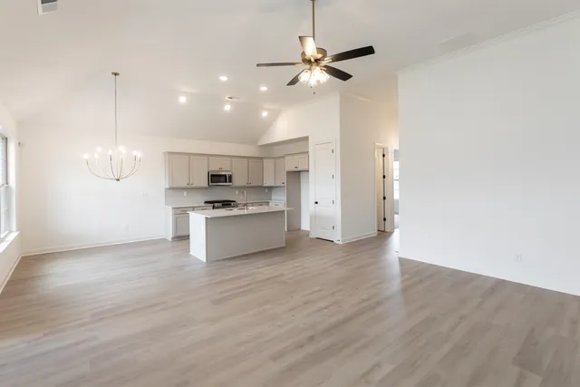 a view of kitchen with granite countertop cabinets and refrigerator