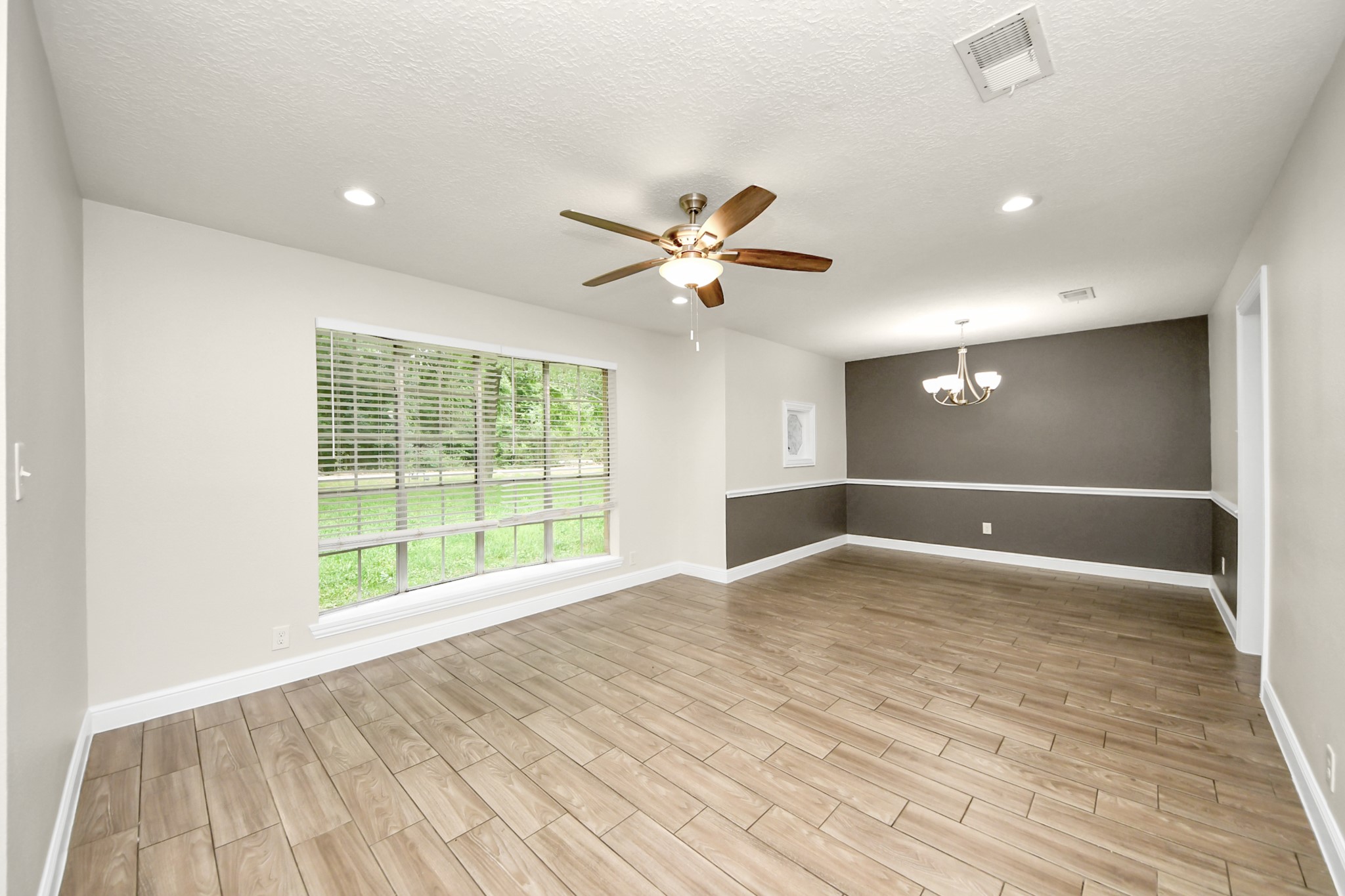 19435 Interstate 45 Spring, TX 77388 - Photo 6 of 24 a view of an empty room with a window and wooden floor