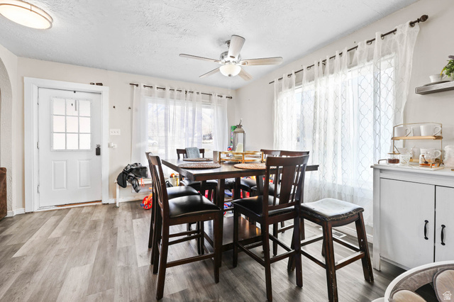 7609 Mountain View Road Lake Point, UT 84074 - Photo 8 of 16 Dining area with light wood finished floors, a textured ceiling, and a ceiling fan