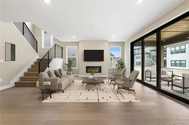 a living room with furniture large window and a flat screen tv