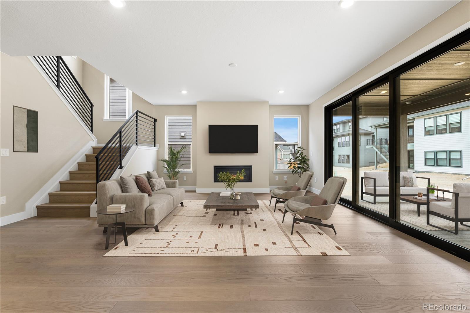 11118 Encantado Trail Lone Tree, CO 80134 - Photo 11 of 50 a living room with furniture large window and a flat screen tv