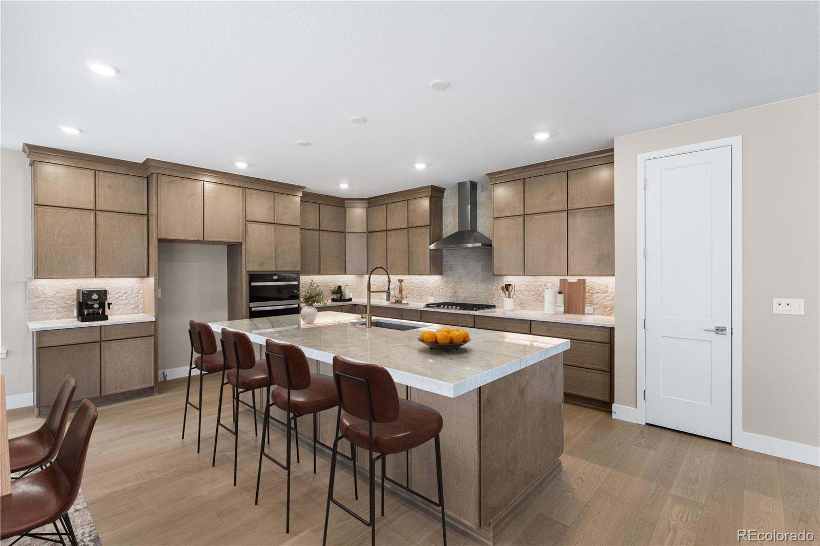 11118 Encantado Trail Lone Tree, CO 80134 - Photo 15 of 50 a kitchen with a table chairs and a refrigerator