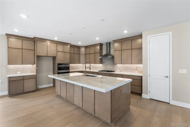 a kitchen with a sink a stove a refrigerator and a cabinets