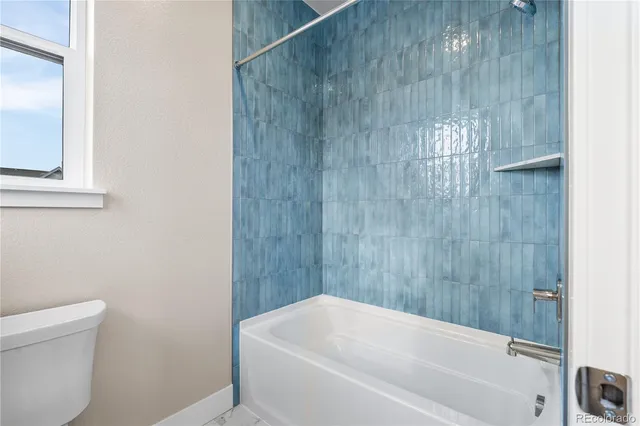 a bathroom with a bathtub and a toilet