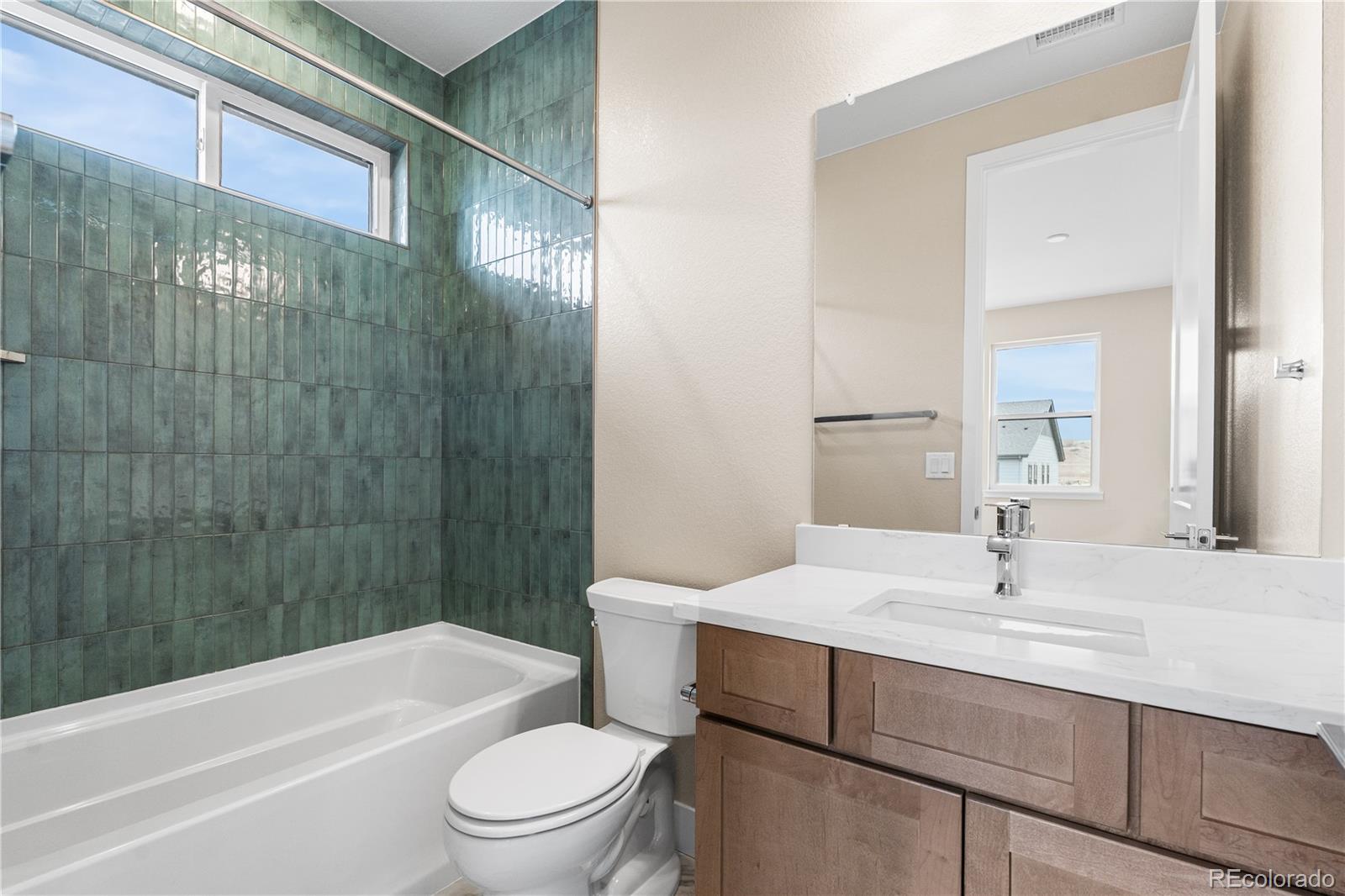 11118 Encantado Trail Lone Tree, CO 80134 - Photo 27 of 50 a bathroom with a sink a toilet and shower
