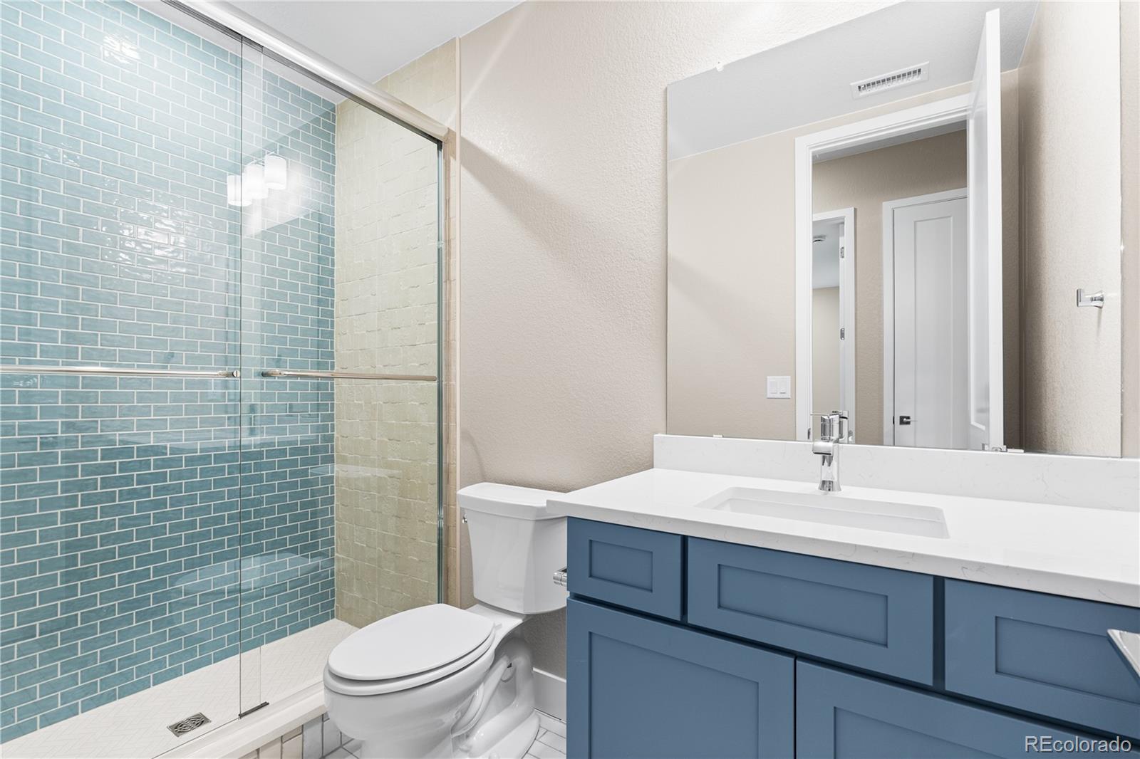 11118 Encantado Trail Lone Tree, CO 80134 - Photo 28 of 50 a bathroom with a sink a toilet and shower