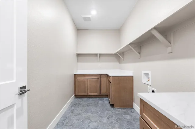 a view of storage and utility room with closet