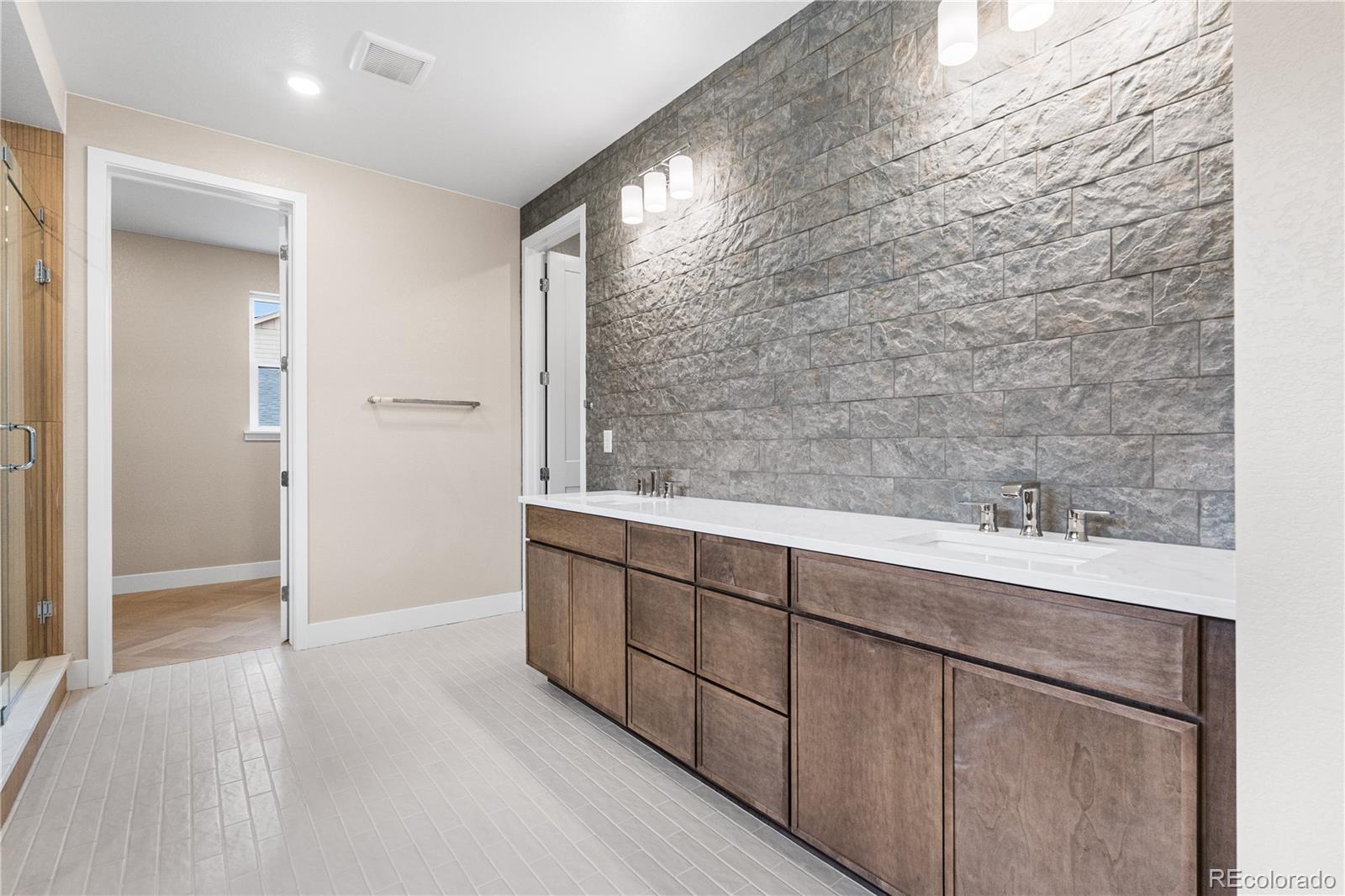 11118 Encantado Trail Lone Tree, CO 80134 - Photo 37 of 50 a bathroom with a sink and a mirror