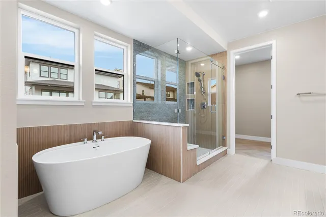 a white bath tub sitting next to a bathroom