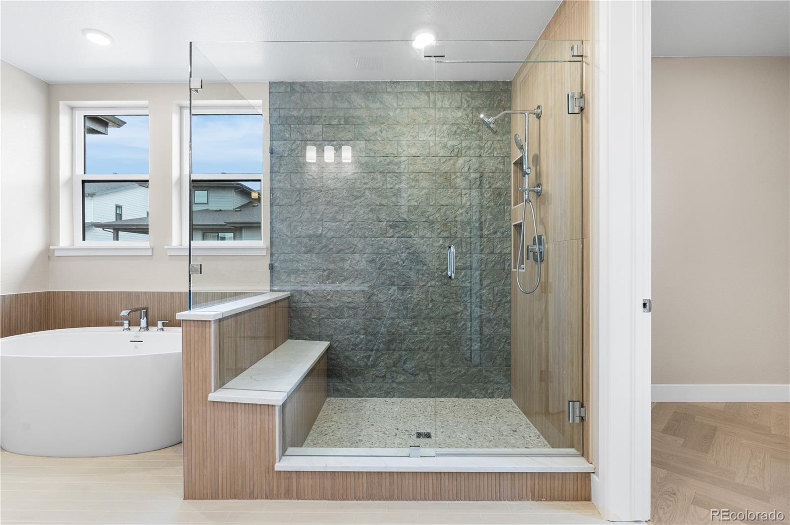 11118 Encantado Trail Lone Tree, CO 80134 - Photo 40 of 50 a bathroom with a bathtub and a shower