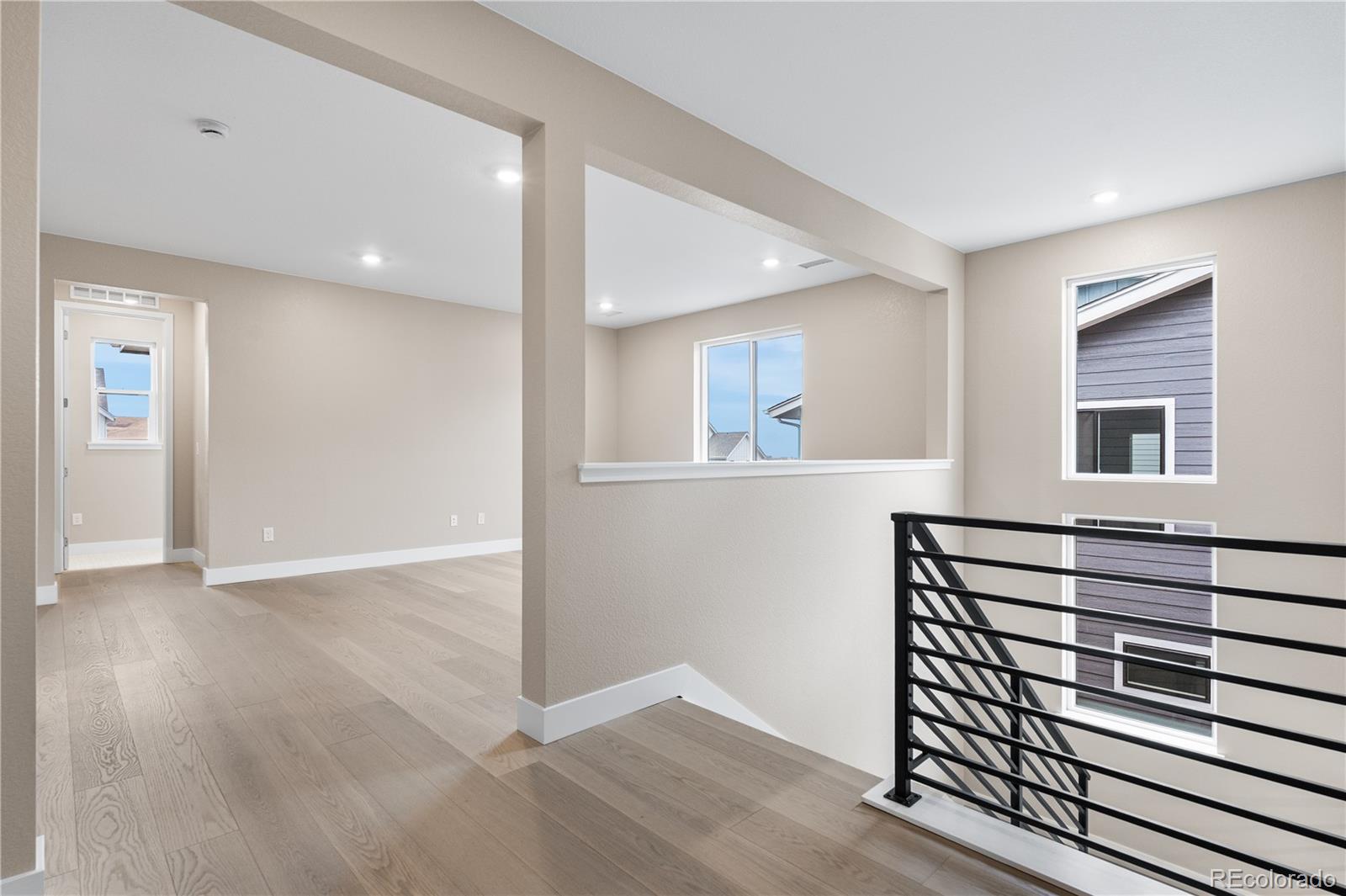 11118 Encantado Trail Lone Tree, CO 80134 - Photo 42 of 50 a view of a hallway with wooden floor and a cabinet