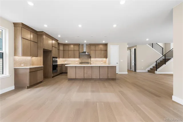 a view of a kitchen with a sink and dishwasher a refrigerator with wooden floor