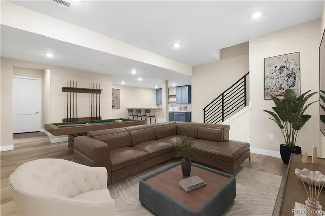a living room with furniture and a potted plant