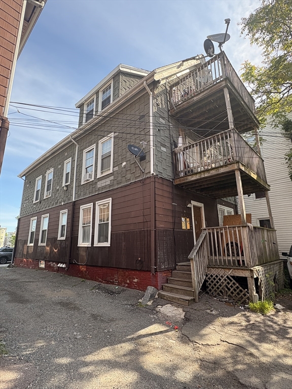 140 South Common Street Lynn, MA 01902 - Photo 9 of 10 a front view of a house with a yard