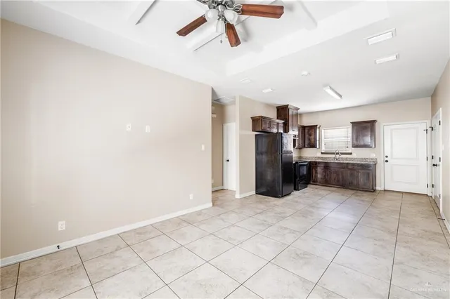 a view of a kitchen with a sink and a refrigerator