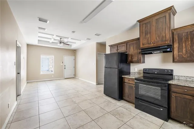 a kitchen with stainless steel appliances granite countertop a refrigerator stove and sink