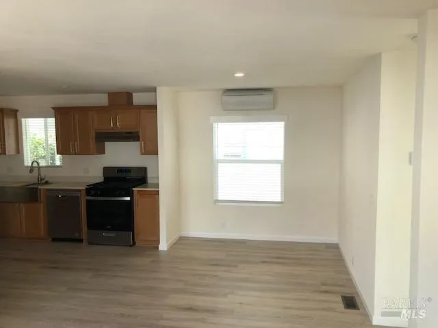 a kitchen with a sink stove and refrigerator